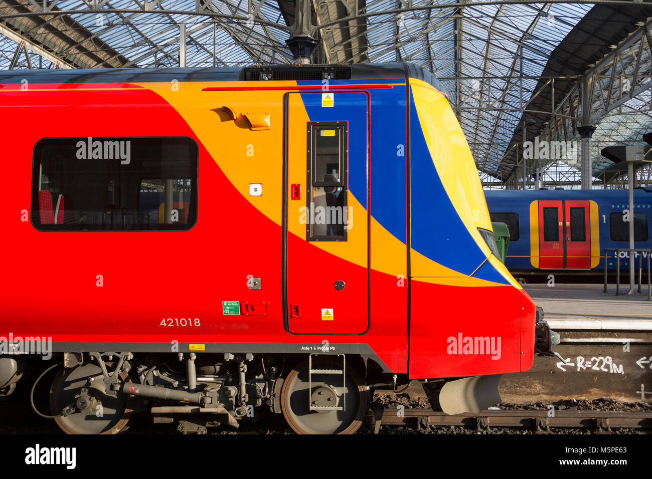 A First Group/MTR South Western Railway Desiro City class 707 train, built by Siemens, waiting at at the station. Stock Photo