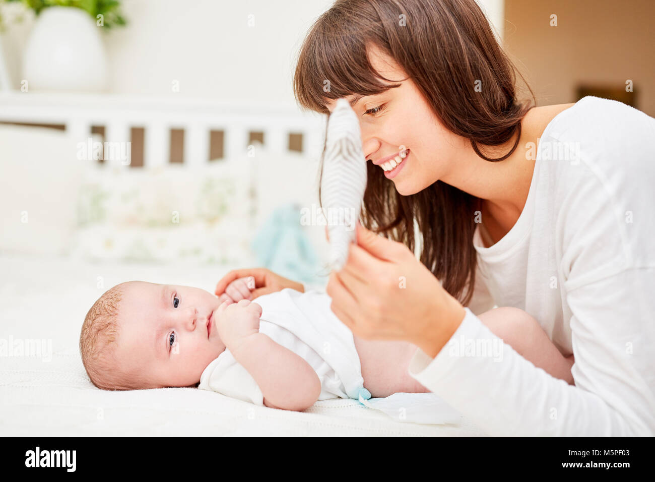 Mother changing diapers with her newborn baby Stock Photo