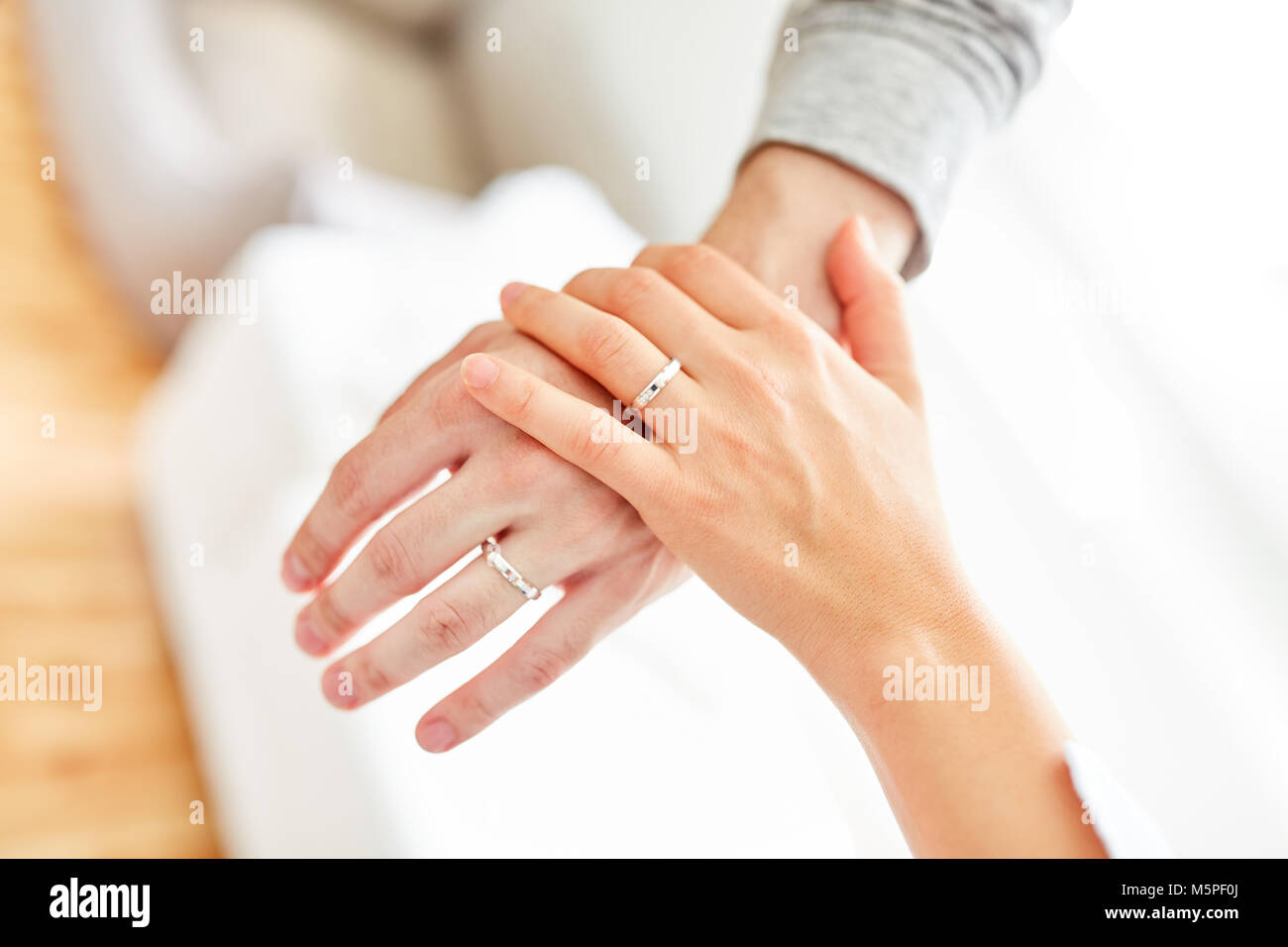 graceful | Right hand of a young woman with a brilliant ring on her ring  finger and red painted fingernails in front of a neutral background. - a  Royalty Free Stock Photo