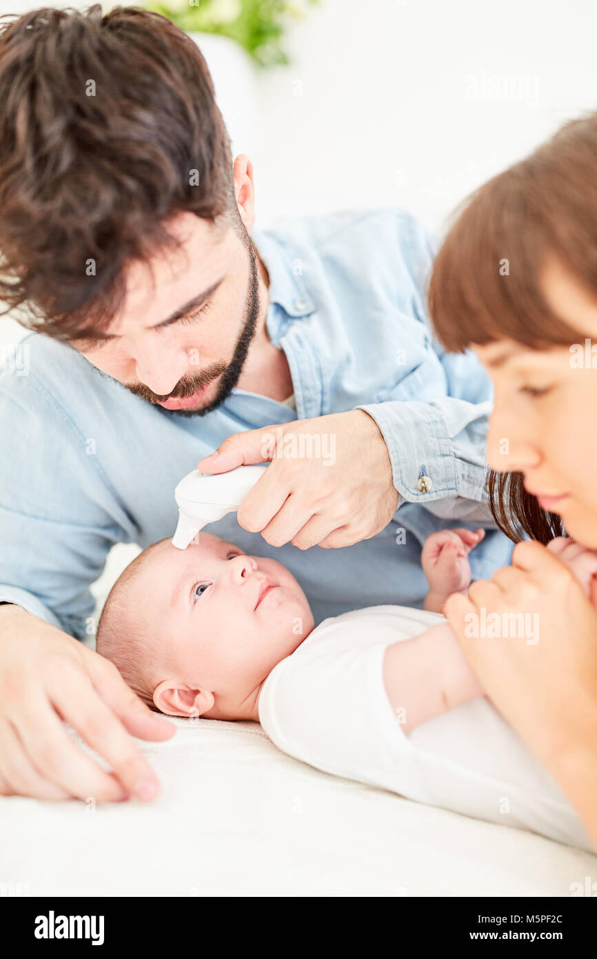 Parents use infrared forehead thermometers to measure the temperature