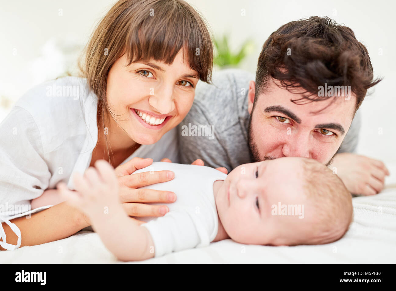 Family as happy parents together with their newborn baby Stock Photo