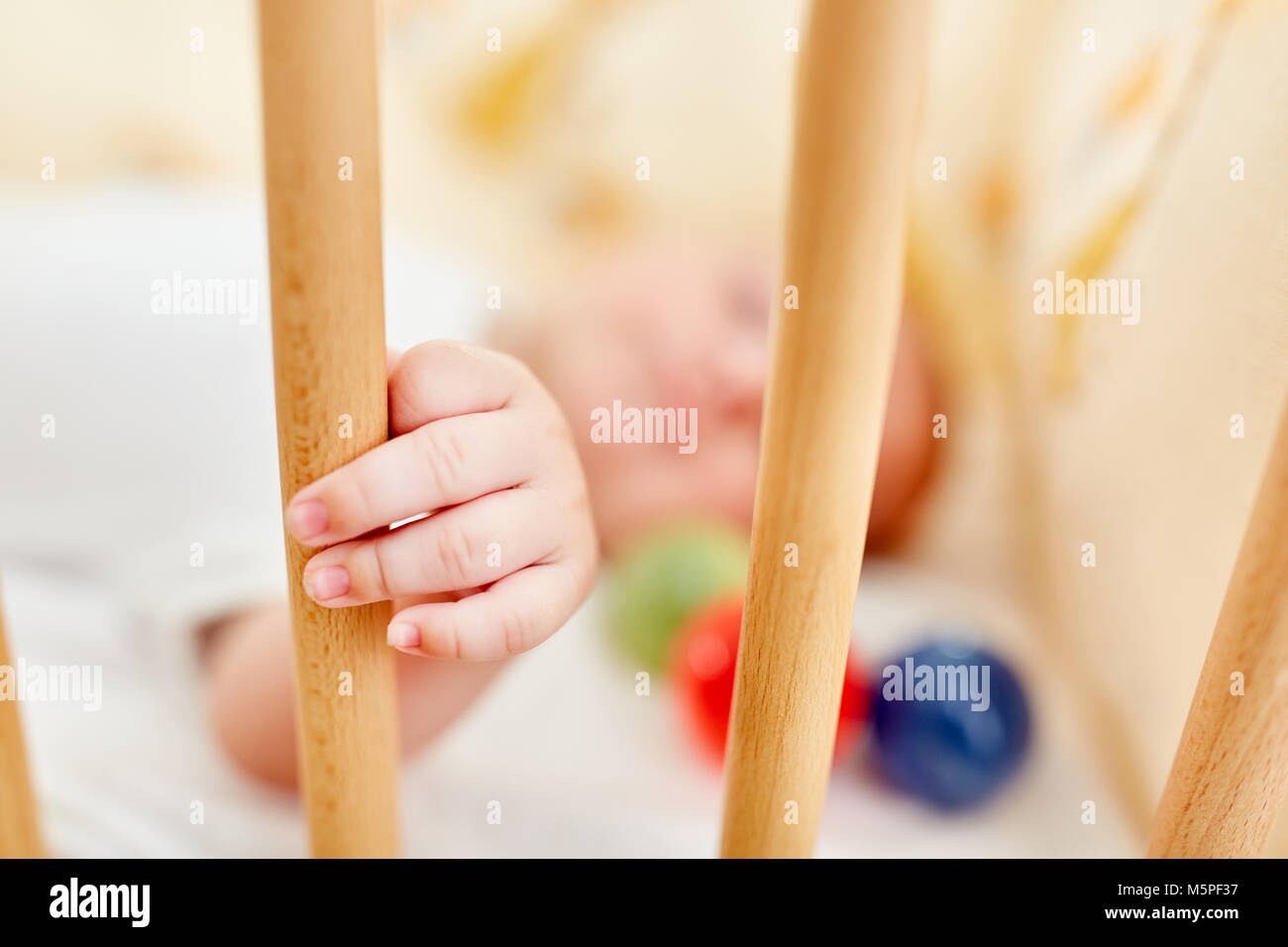 Newborn baby falling asleep in cot Stock Photo Alamy