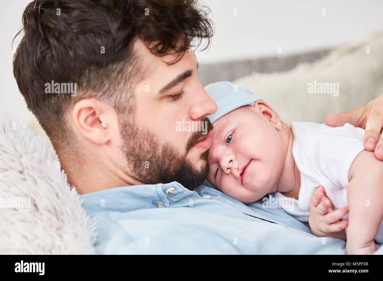 Loving happy father holds newborn baby in the arms Stock Photo