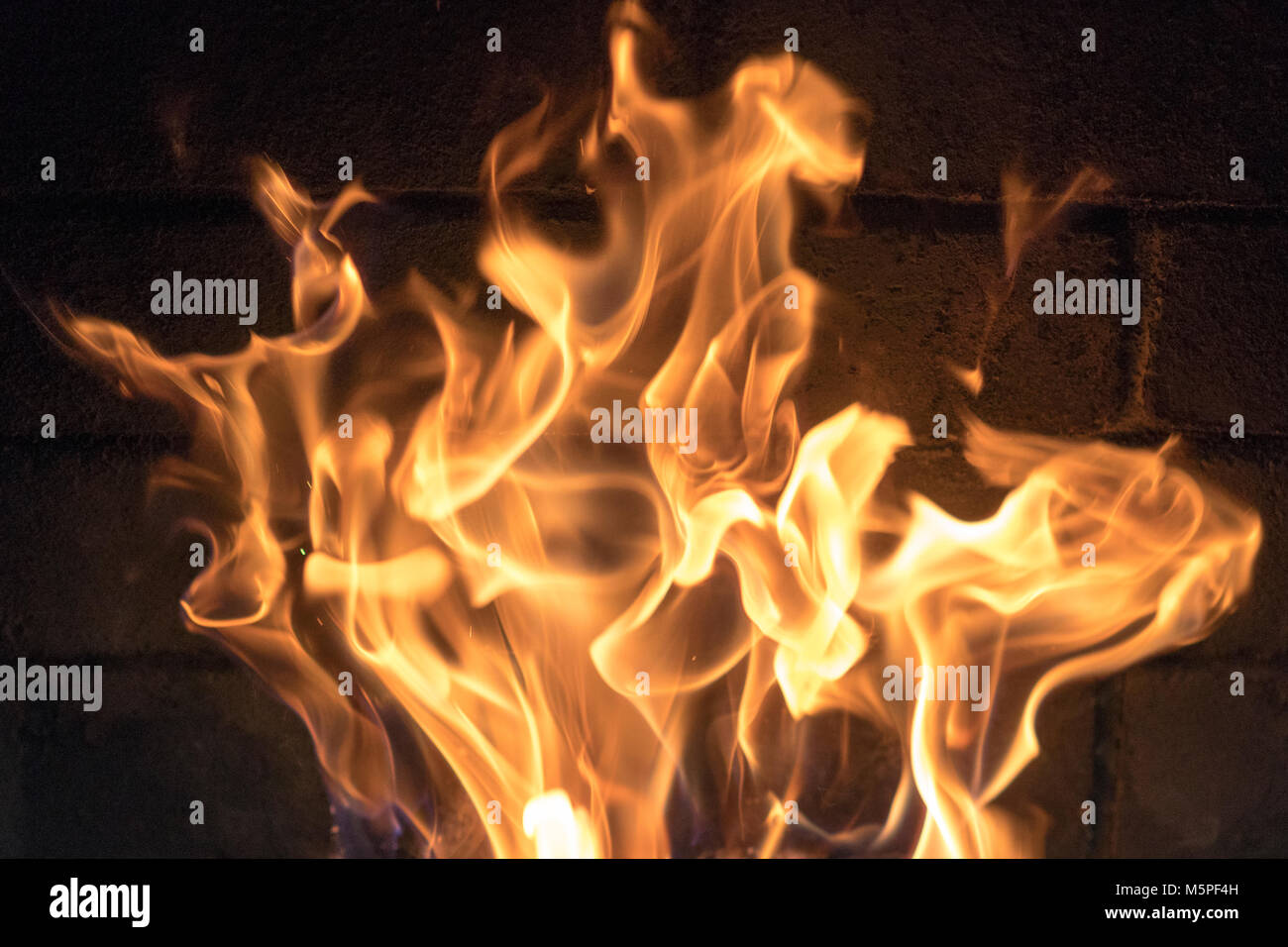 red yellow fire in the fireplace close-up. flames. Fire background ...