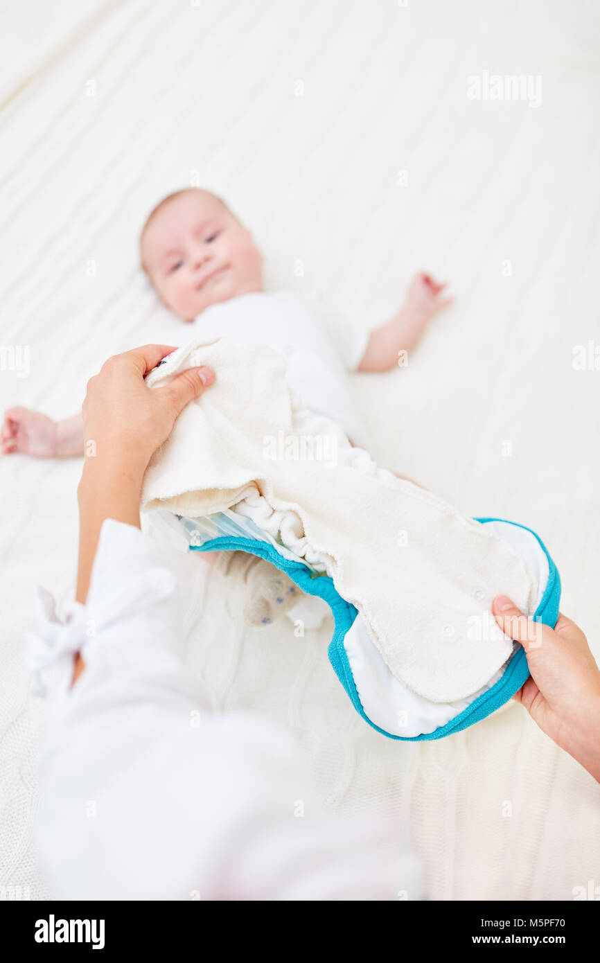 Caring mother changes cloth diapers in her newborn baby Stock Photo Alamy