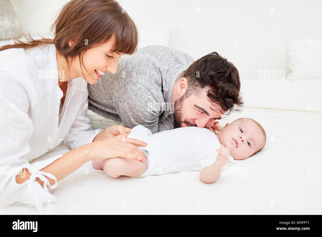 Caring parents changing diaper with their newborn baby Stock Photo