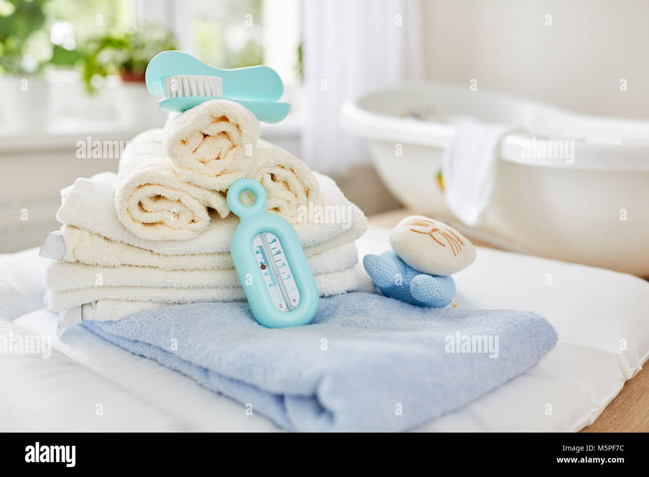 Bathroom with towels and bath thermometer for the baby bath Stock Photo