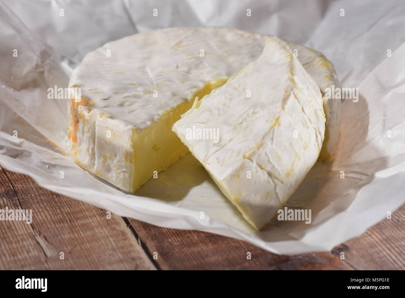 Goats Cheese fresh with the wrapper Stock Photo Alamy