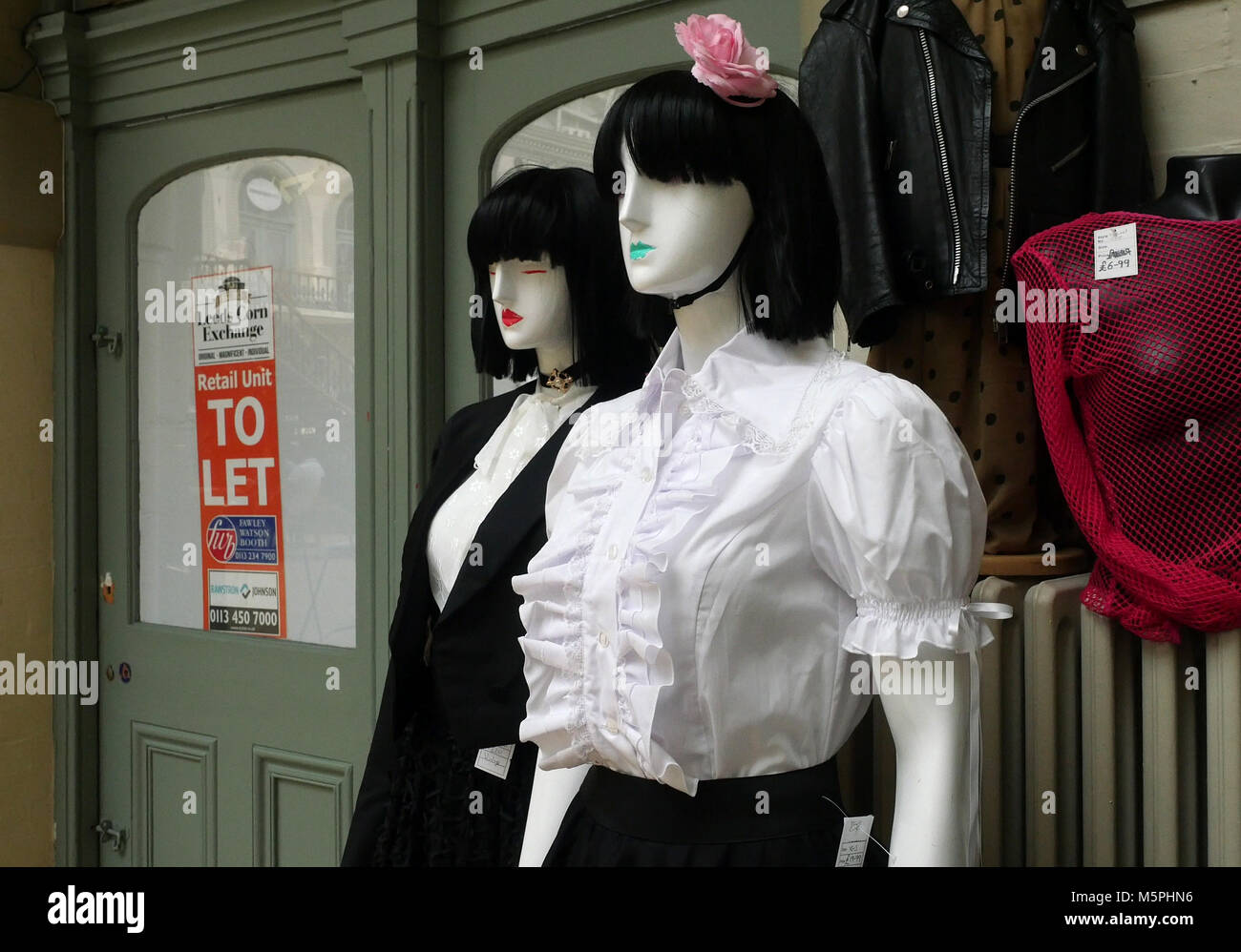 Mannequins outside empty shop in Leeds displaying vintage clothing