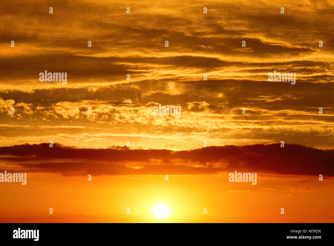 Sunset - the sun low above the horizon Stock Photo