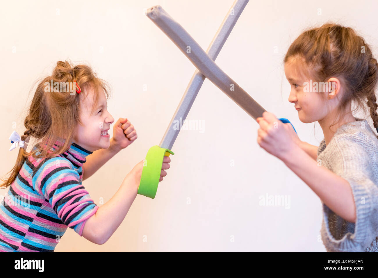 Two little girls are fighting on swords Stock Photo Alamy