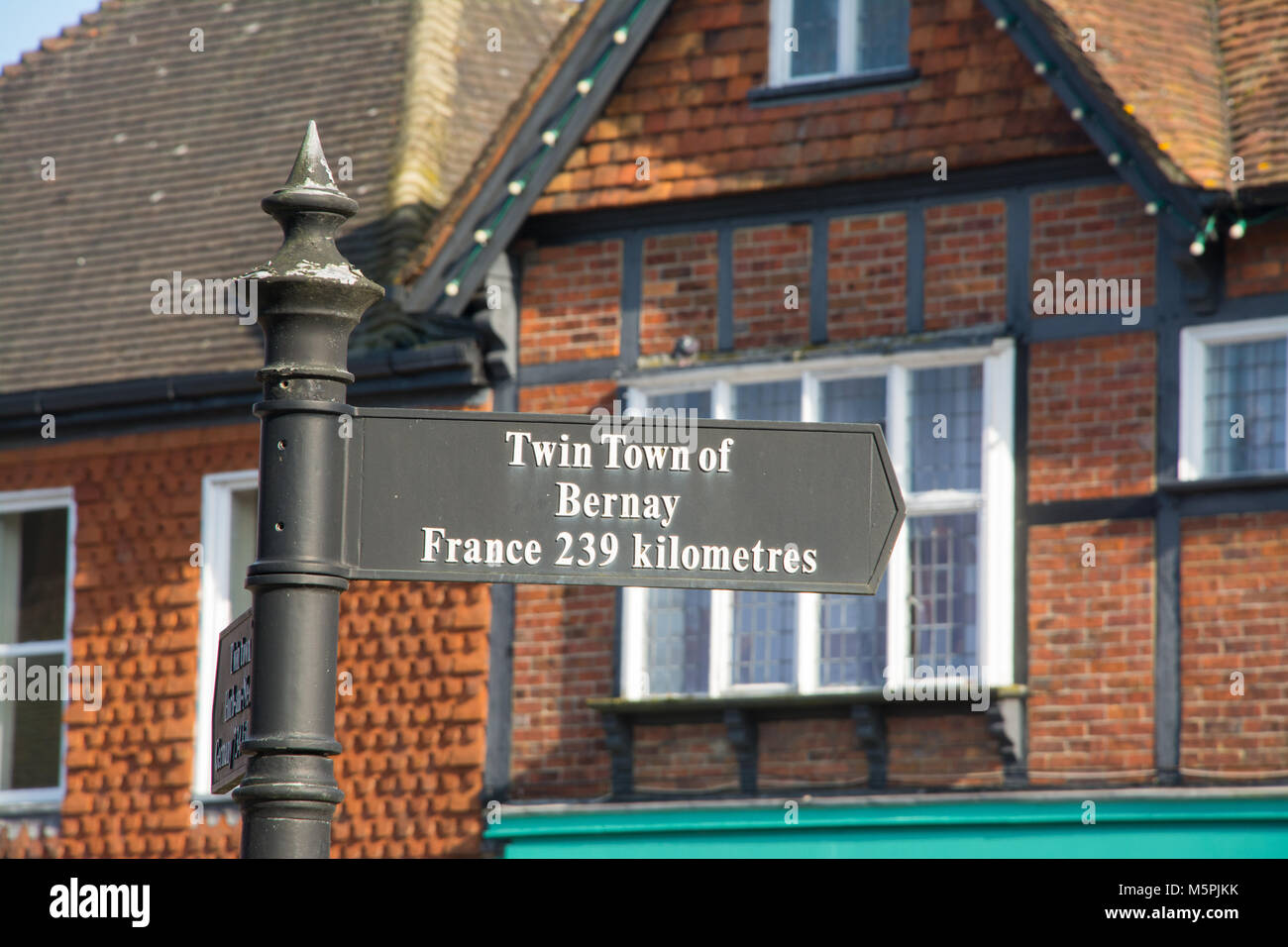 Sign in Haslemere town centre saying twin town of Bernay france 239 kilometres Stock Photo