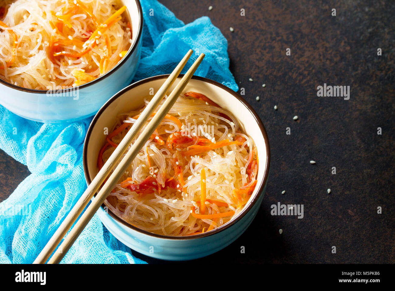 Funchoza salad with rice noodles with paprika, tomatoes and pepper on a