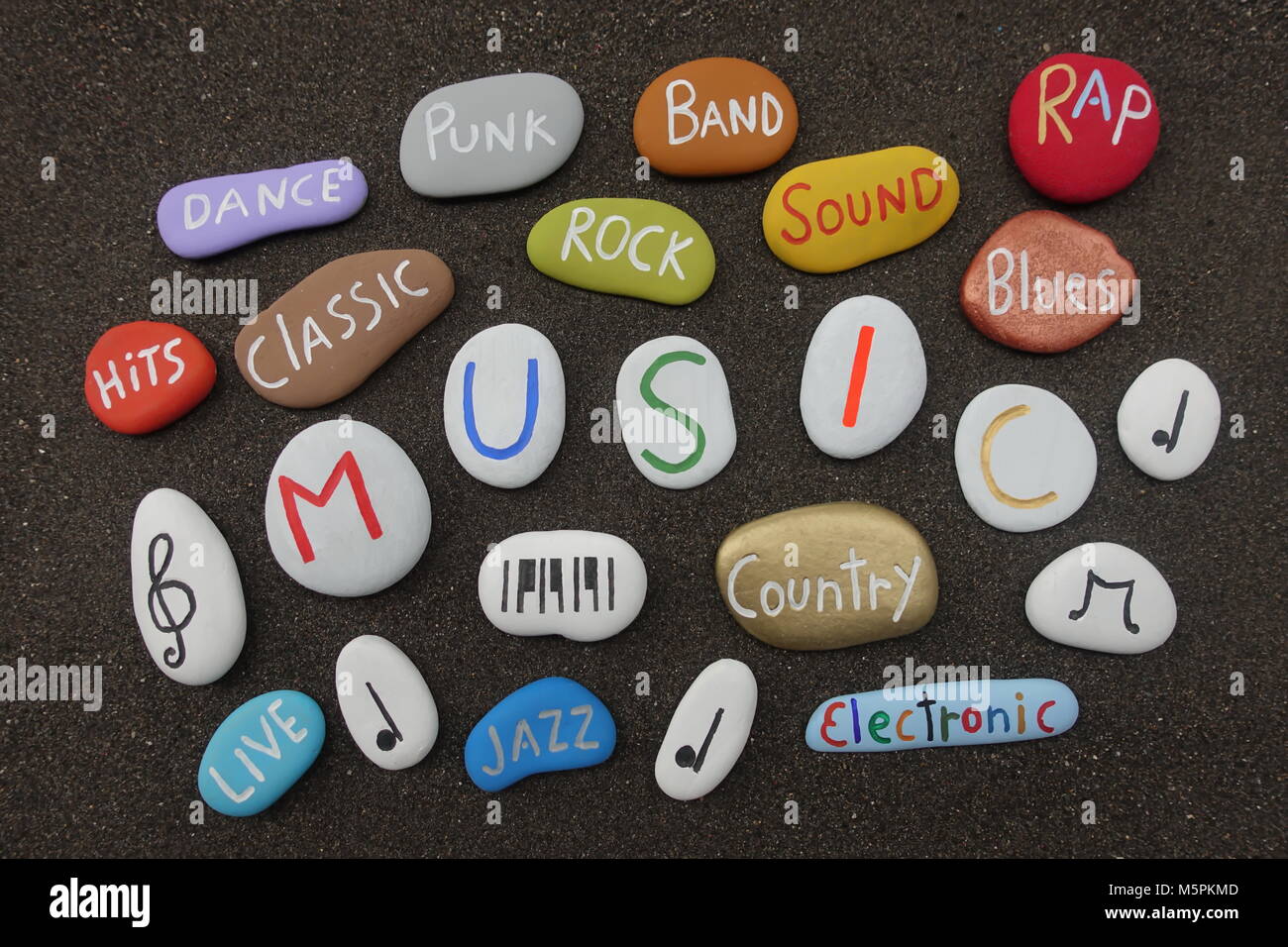 Music cloud with multicolored stones over black volcanic sand Stock Photo