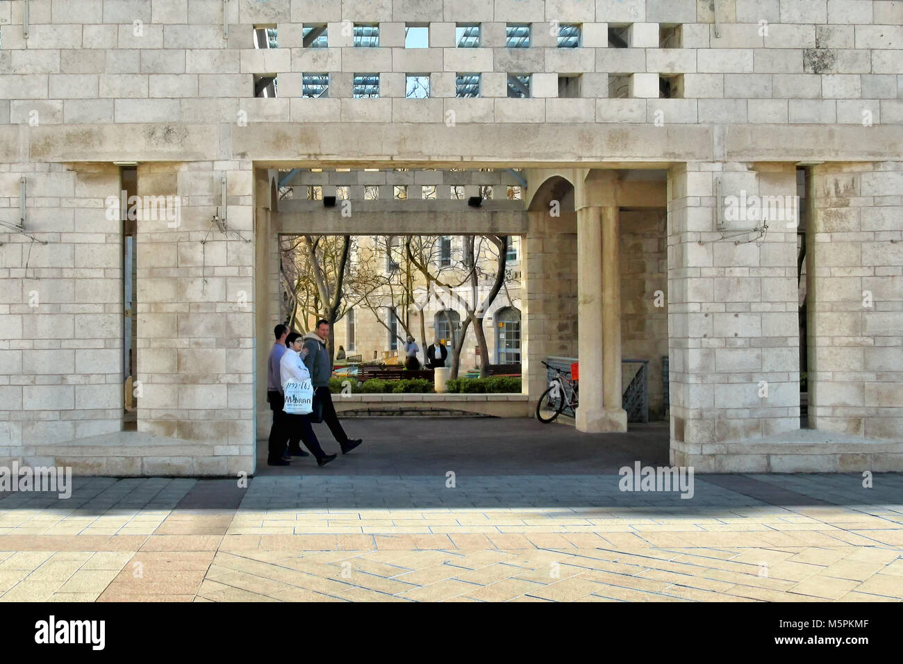 Men walk through the Jerusalem municipality buildings at Safra Square. Stock Photo