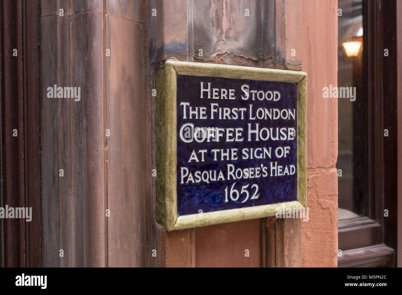 A commemorative plaque marking the location of London's first coffee house, opened by Pasqua Rosee in 1652. St Michaels Alley near Cornhill, London. Stock Photo