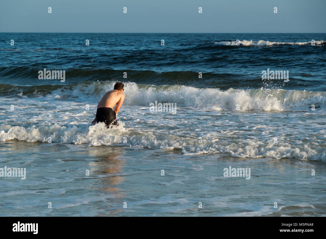 Man wading in the Gulf of Mexico at Orange Beach, Alabama in the winter Stock Photo