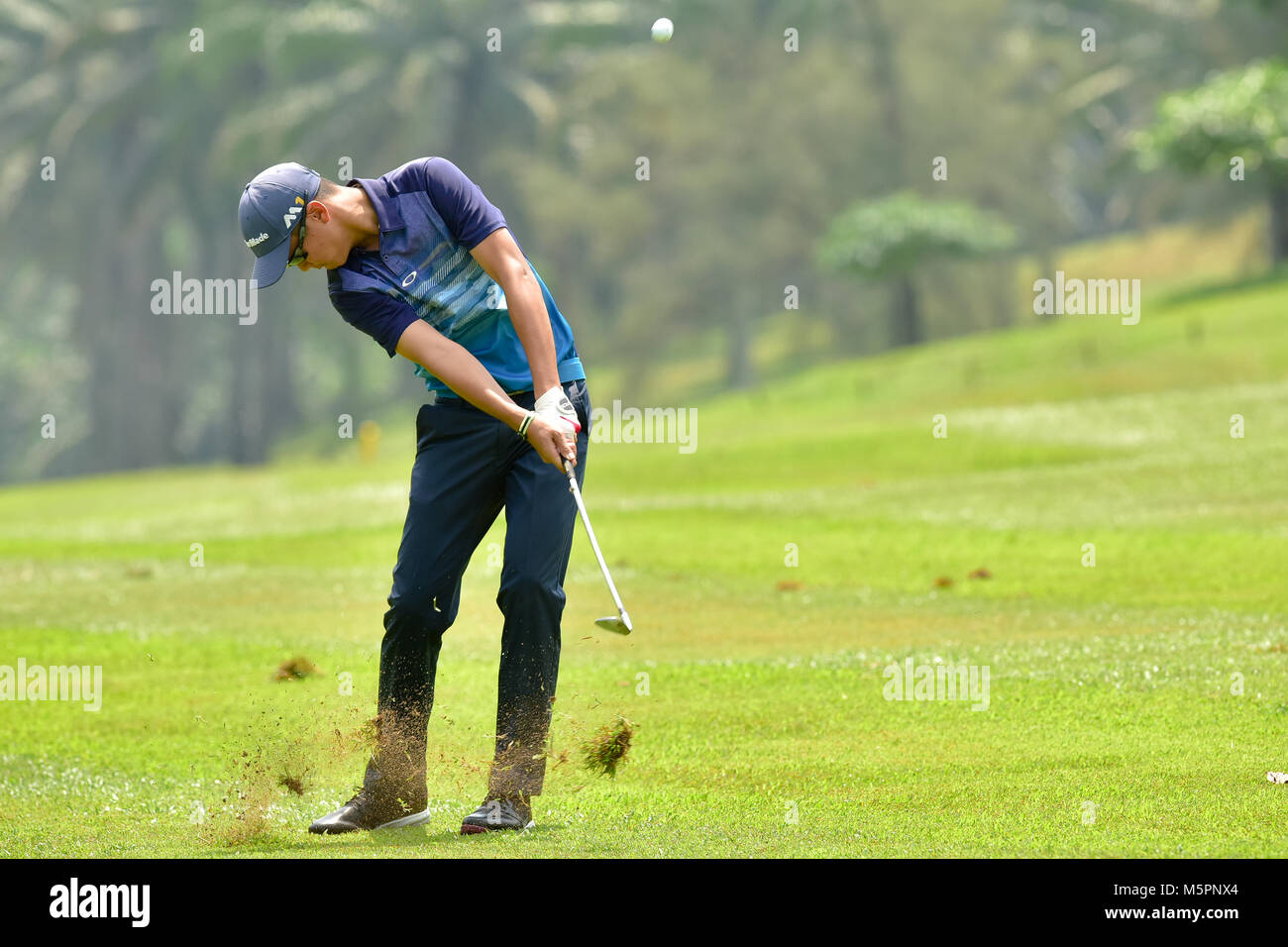 Danau, UKM Bangi - FEBRUARY 11: Marcus Lim Pang Chuen plays his second shot on the 4th hole during Final Round of the Danau Junior Championship at Dan Stock Photo