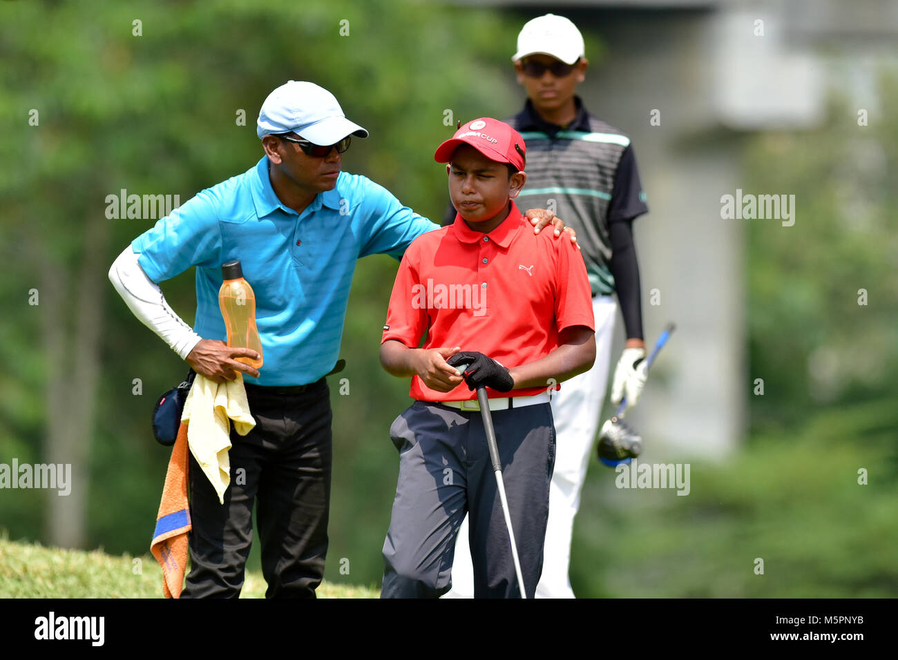 Danau, UKM Bangi - FEBRUARY 11: Basil Devanbu talks to his caddie the 5th hole during Final Round of the Danau Junior Championship at Danau Golf Club  Stock Photo