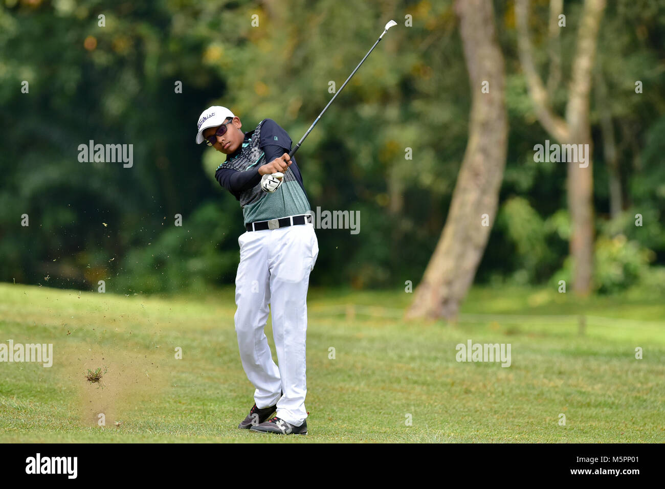 Danau, UKM Bangi - FEBRUARY 11: Vishnu Raja plays his second shot on the 5th hole during Final Round of the Danau Junior Championship at Danau Golf Cl Stock Photo