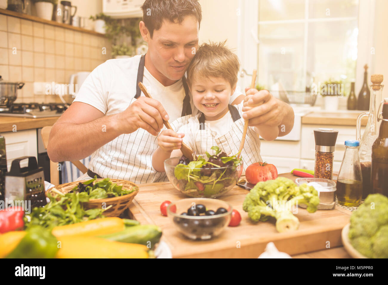 Father is cooking with his son Stock Photo