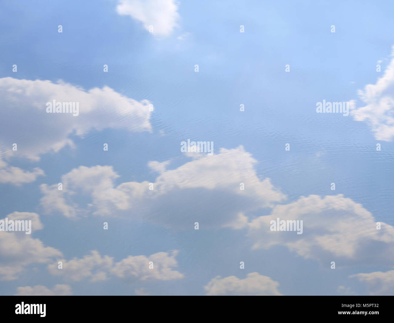 Blue sky and white clouds reflection on water Stock Photo - Alamy
