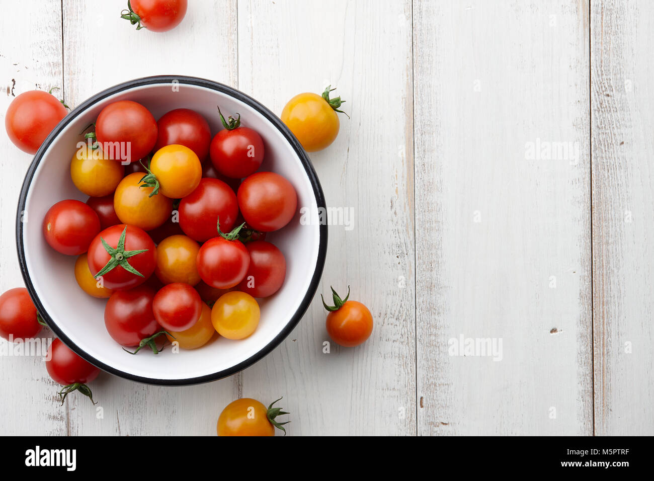Bright red and yellow tomatoes on white wooden table, top view Stock ...