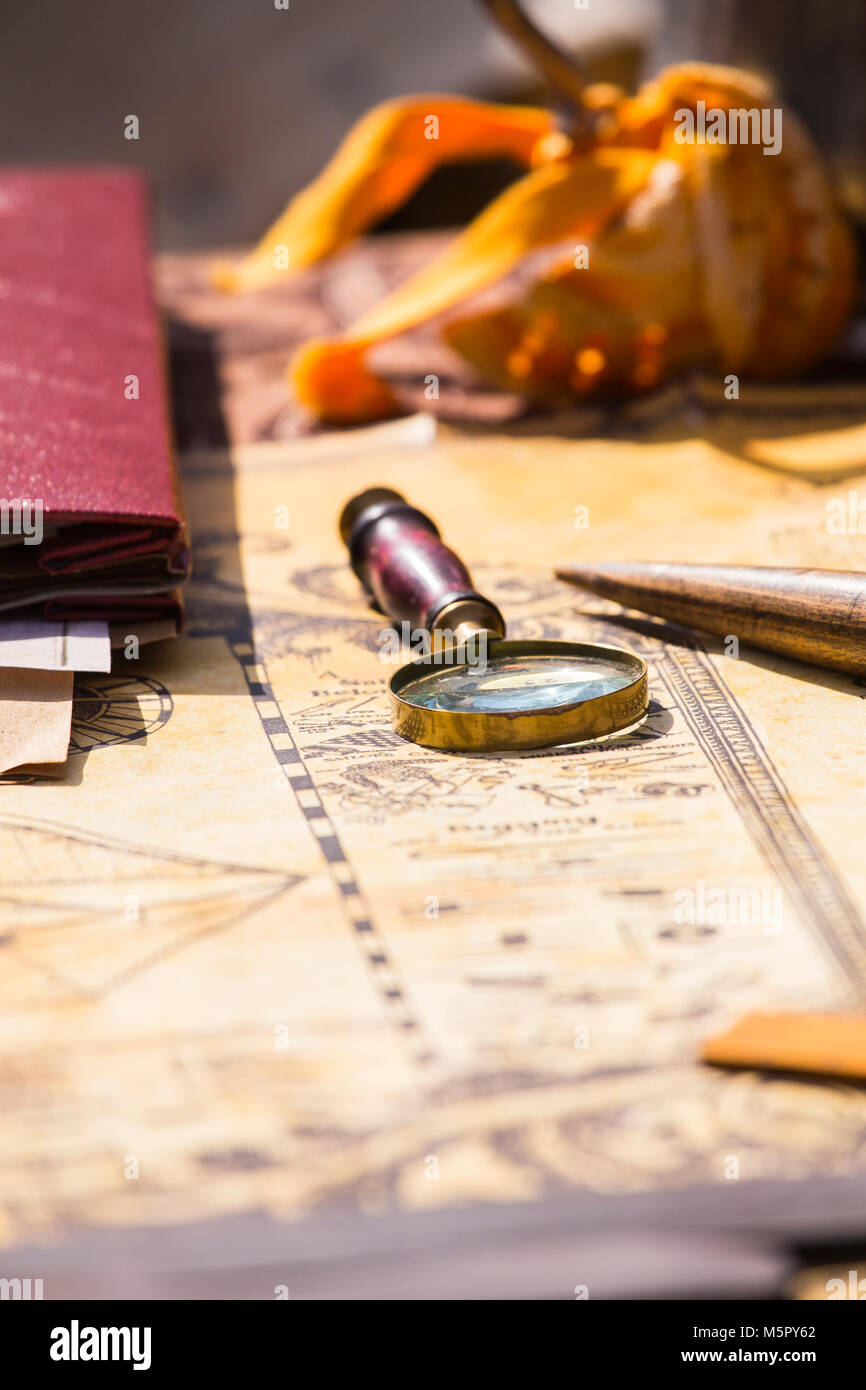 A brass magnifying glass with a wood handle on a old fashion map Stock ...