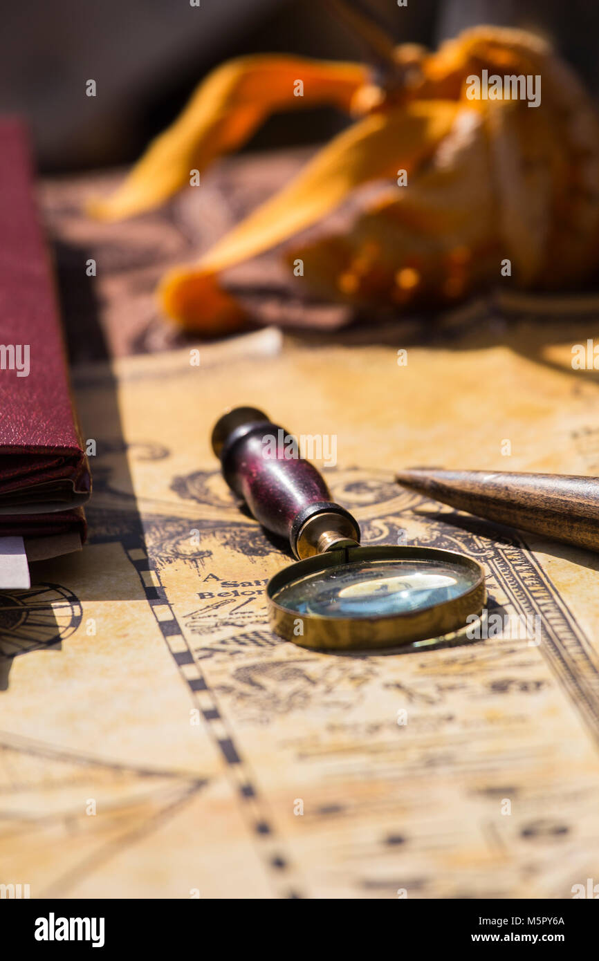 A brass magnifying glass with a wood handle on a old fashion map Stock ...