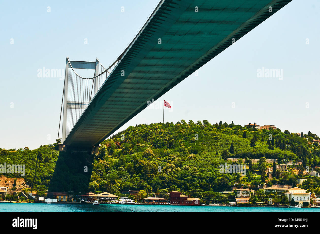 Istanbul bridge Turkey seen from bellow blue sky and turquoise water Stock Photo