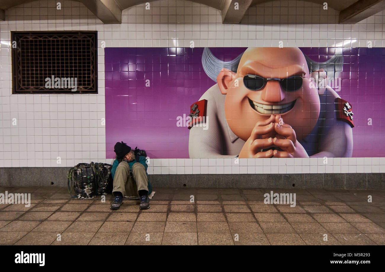Homeless man sleeping on a MTA corridor at Bryant Park Subway station Stock Photo