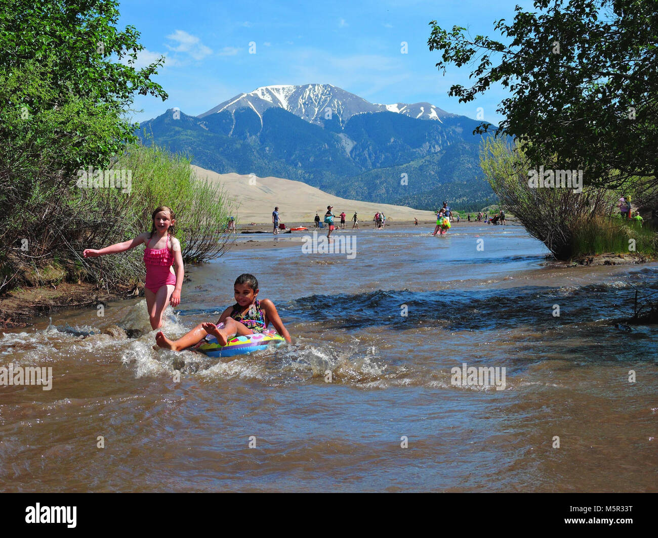 Girls Floating and Splashing in Medano Creek Stock Photo - Alamy