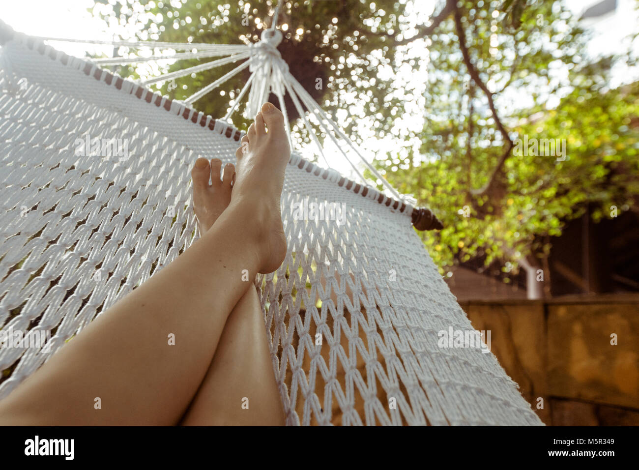 Crop person chilling in hammock Stock Photo