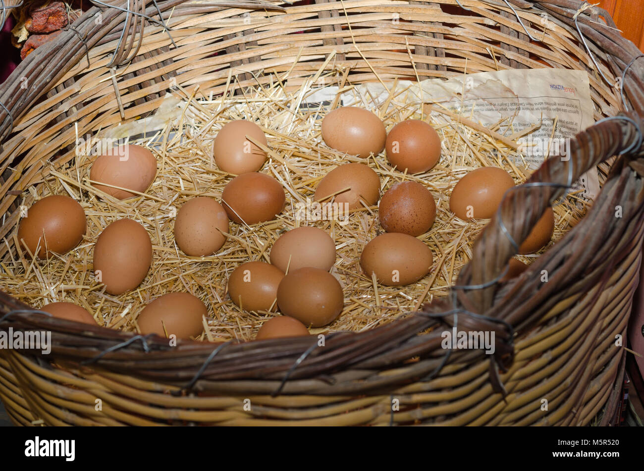 chicken eggs lying in the nest of straw. Top view Stock Photo - Alamy