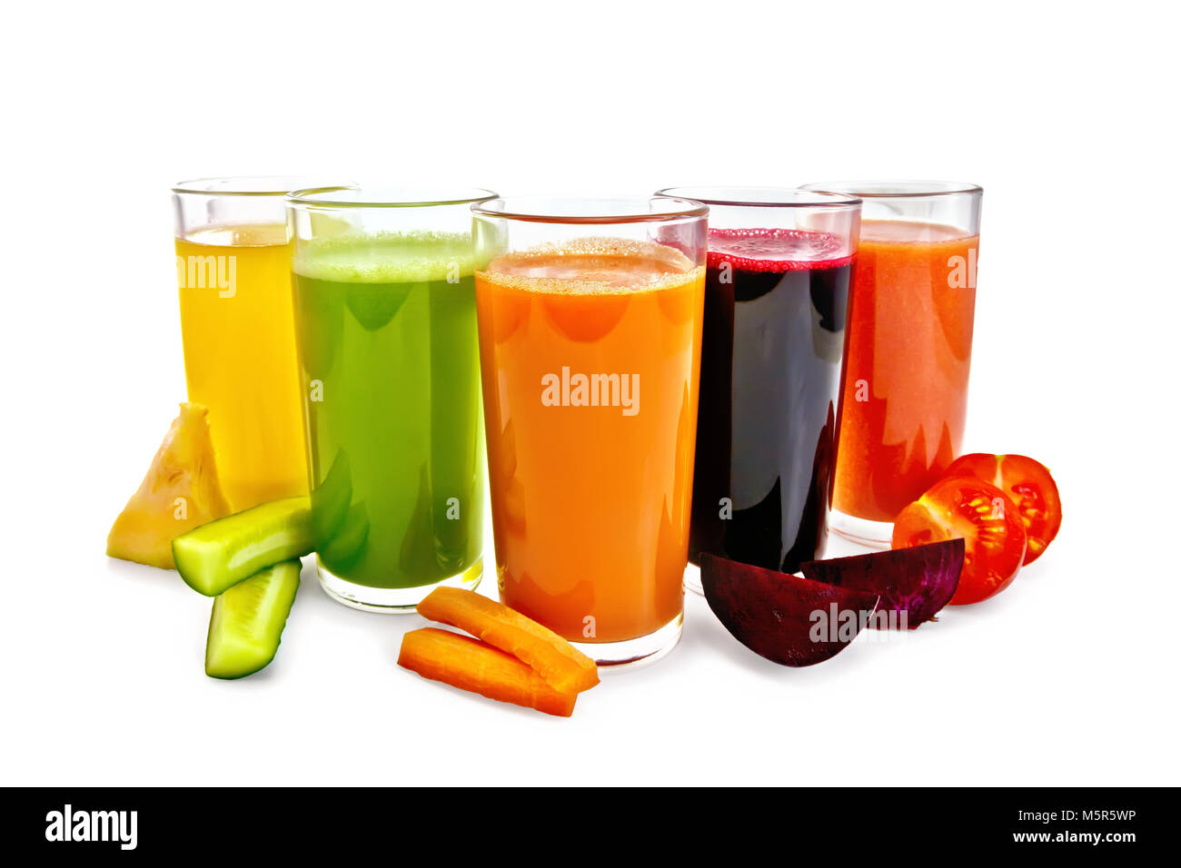 Five tall glasses with juice of carrot, cucumber, tomato, beetroot and pumpkin with vegetable slices isolated on white background Stock Photo