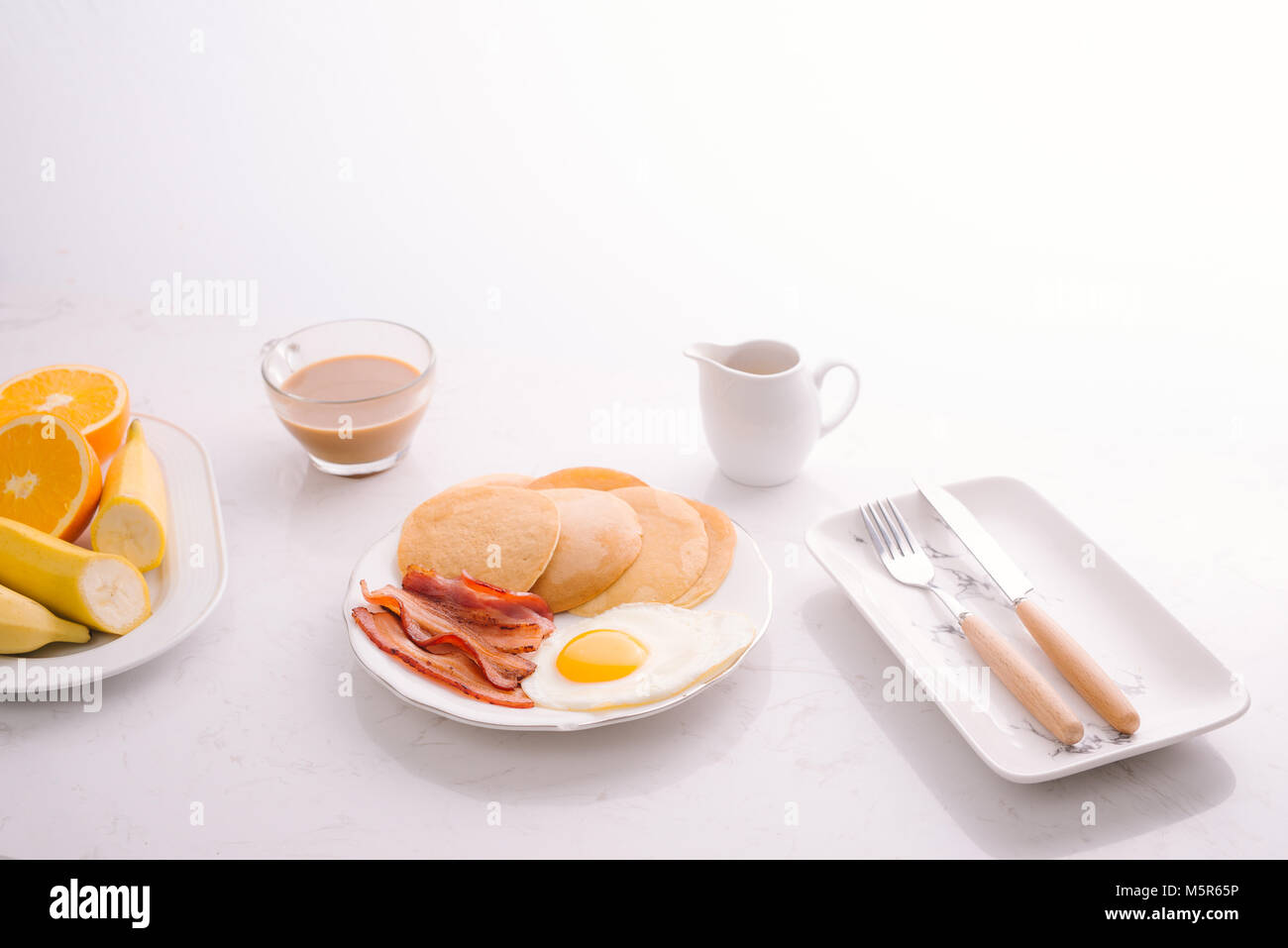Breakfast plate with pancakes, eggs, bacon and fruit Stock Photo Alamy