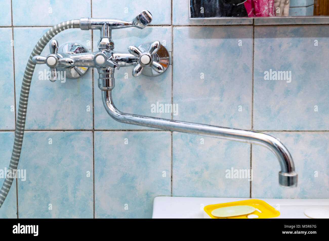 Faucet mixer tap in bathroom on tile background Stock Photo - Alamy