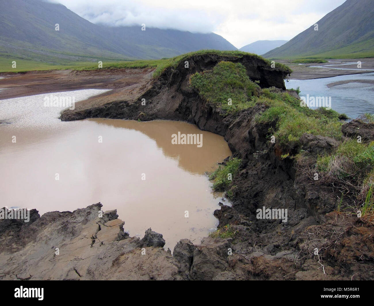 Permafrost Thaw . Have you ever seen a lake disappear? Permafrost is thawing across the Arctic, causing northern lands to sink or change shape. In Gates of the Arctic National Park, a bank of this lake thawed, allowing the Okokmilaga River to cut through and drain it to sea. Although it's the short-term impacts that are most noticeable to us, scientists are particularly concerned about what will happen as the frozen ground releases carbon dioxide and methane that were formerly stored under the surface. Stock Photo