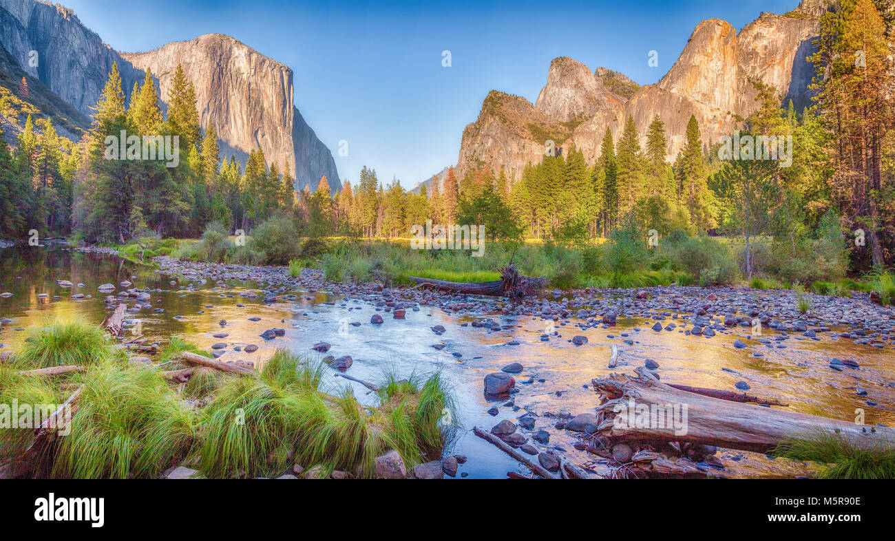 Panoramic view of famous Yosemite Valley with scenic Merced river in beautiful golden evening light at sunset in summer, Yosemite National Park, Marip Stock Photo