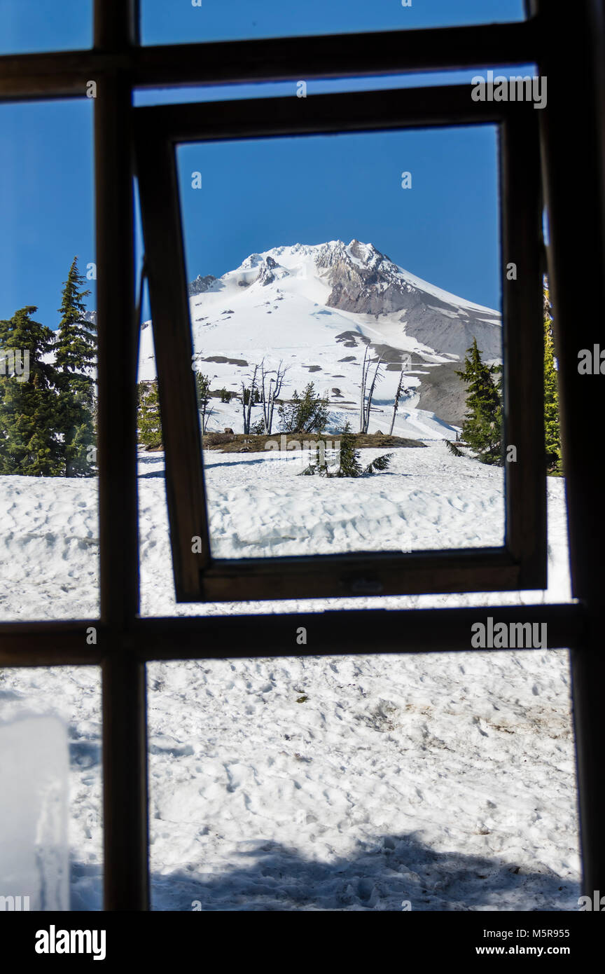 View of Palmer Snow Field on Mt Hood through one of the TImberline Lodge window frames Stock Photo