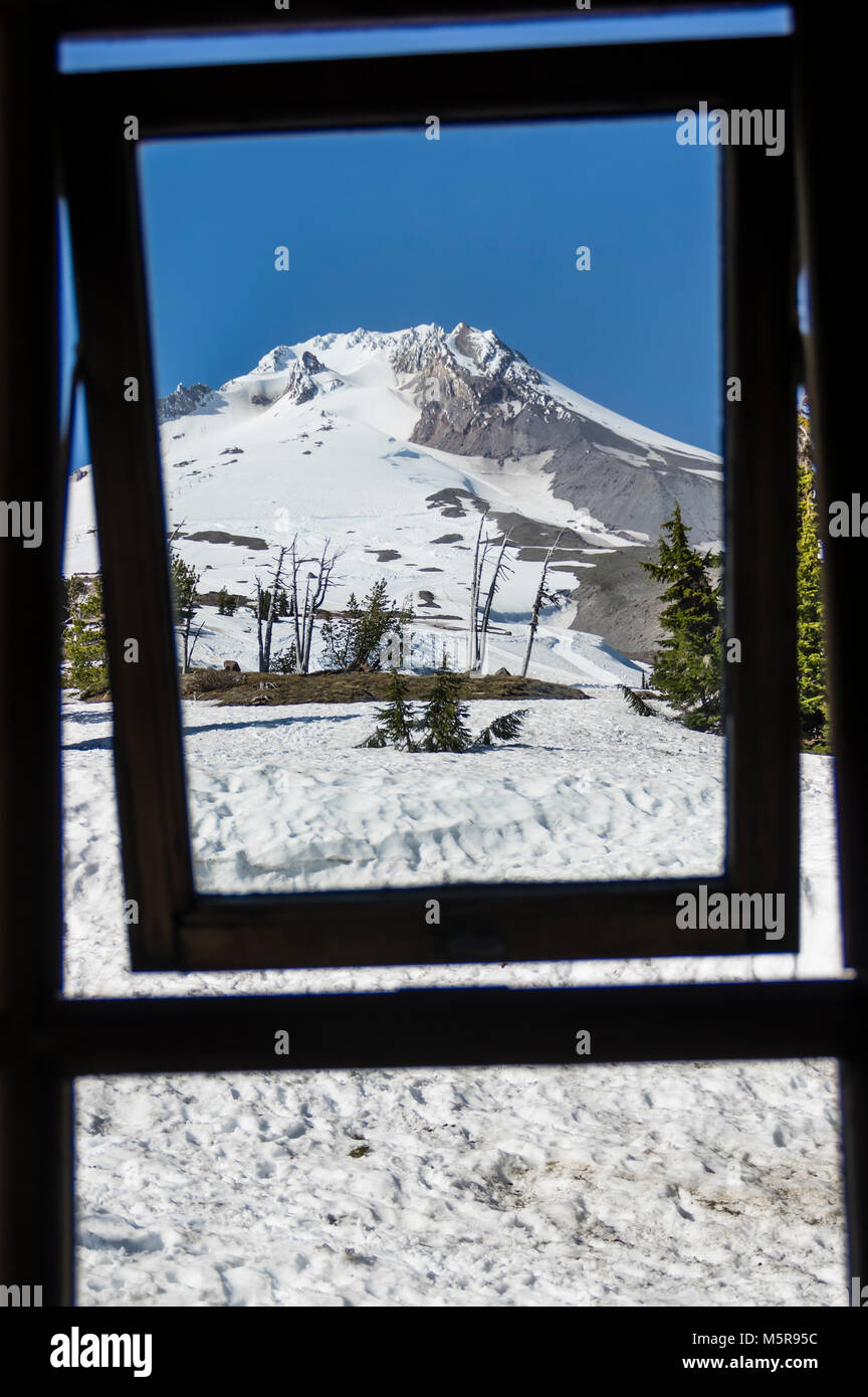 View of Palmer Snow Field on Mt Hood through one of the TImberline Lodge window frames Stock Photo