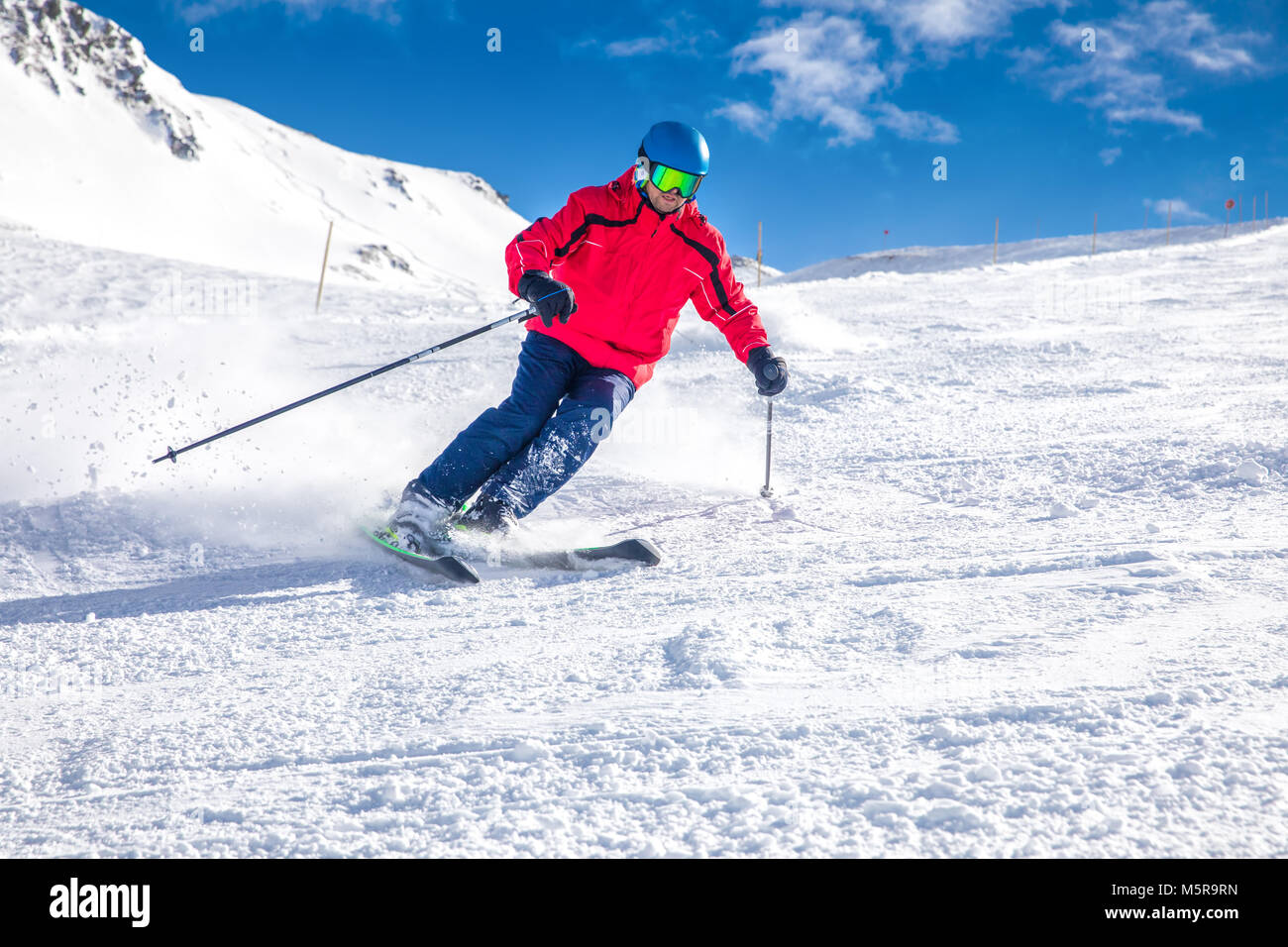 Man skiing on the prepared slope with fresh new powder snow in Tyrolian Alps, Zillertal, Austria Stock Photo