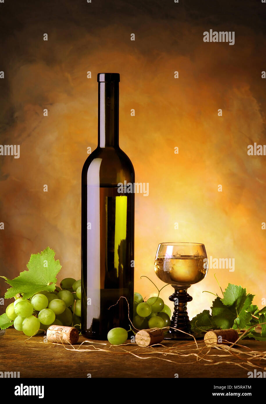Still life with wine bottle, glass, grapes and vine leaves Stock Photo ...