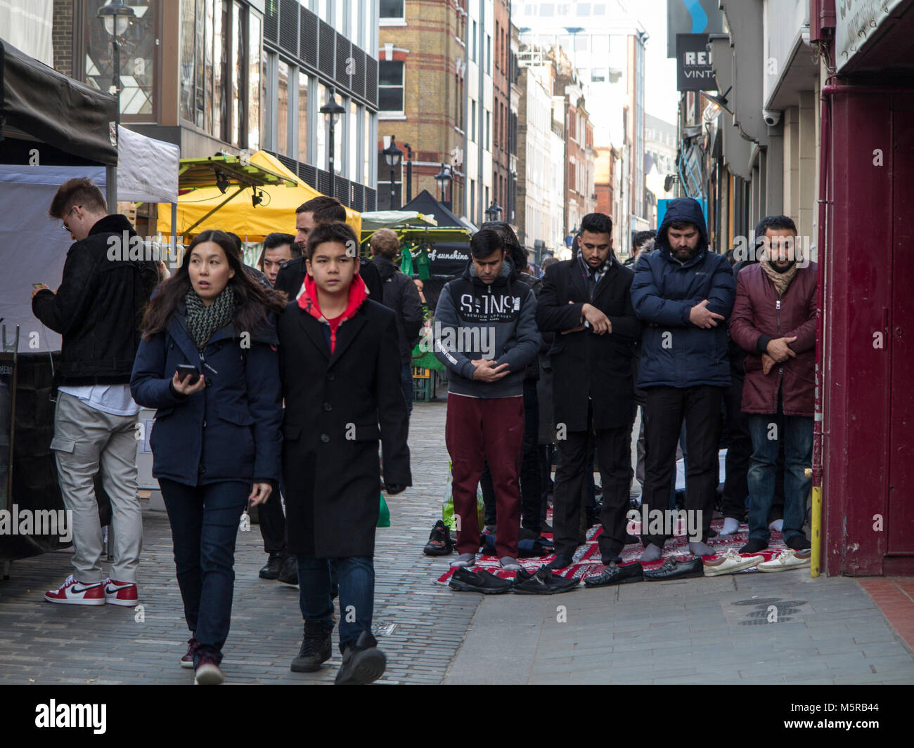 Muslims hold their Friday prayers in Berwick Street, Soho Stock Photo