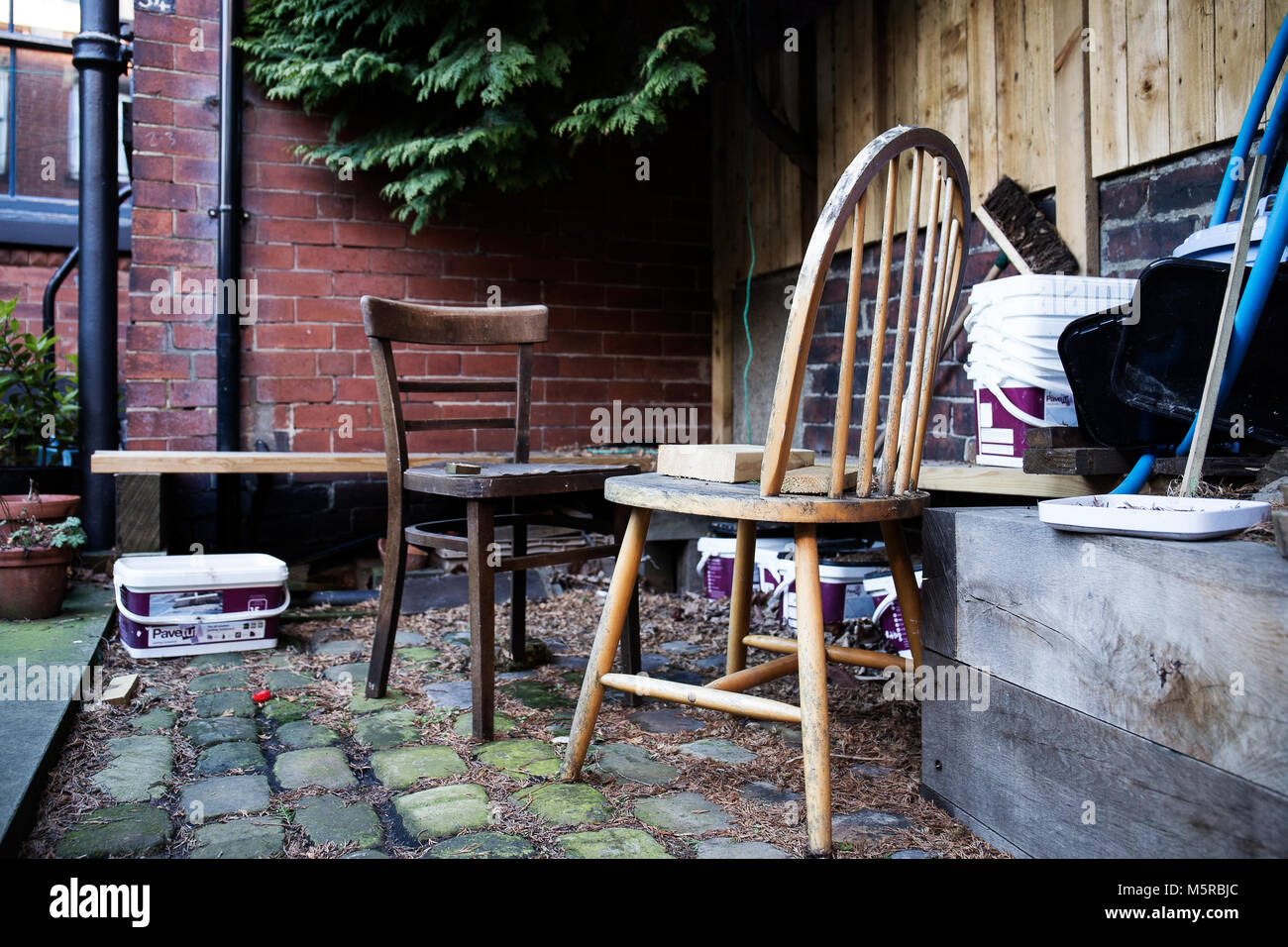 Two wooden chair in an old back yard. Stock Photo