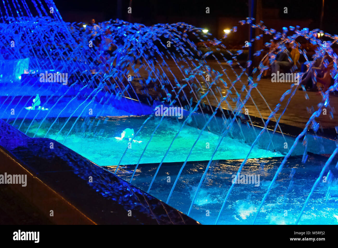 blue streams of glowing fountain, illuminated fountain at night Stock ...