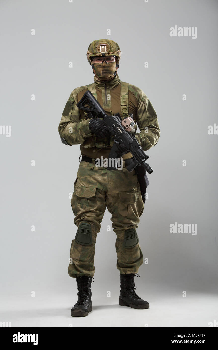 Full-length picture of military man in camouflage with gun Stock Photo ...