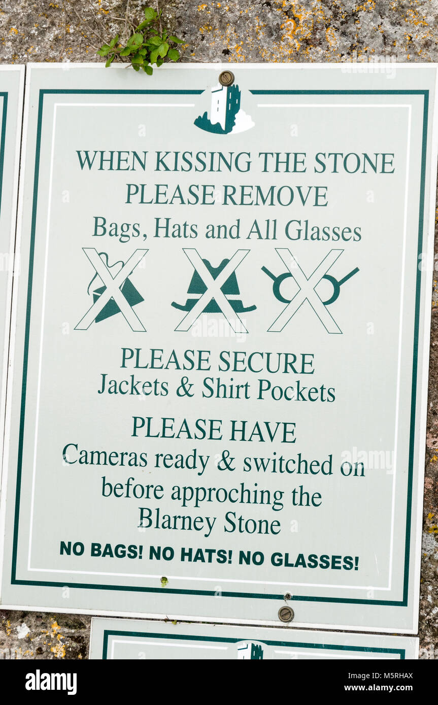 An advisory notice for visitors wanting to kiss the Blarney Stone at Blarney Castle in Southern Ireland Stock Photo