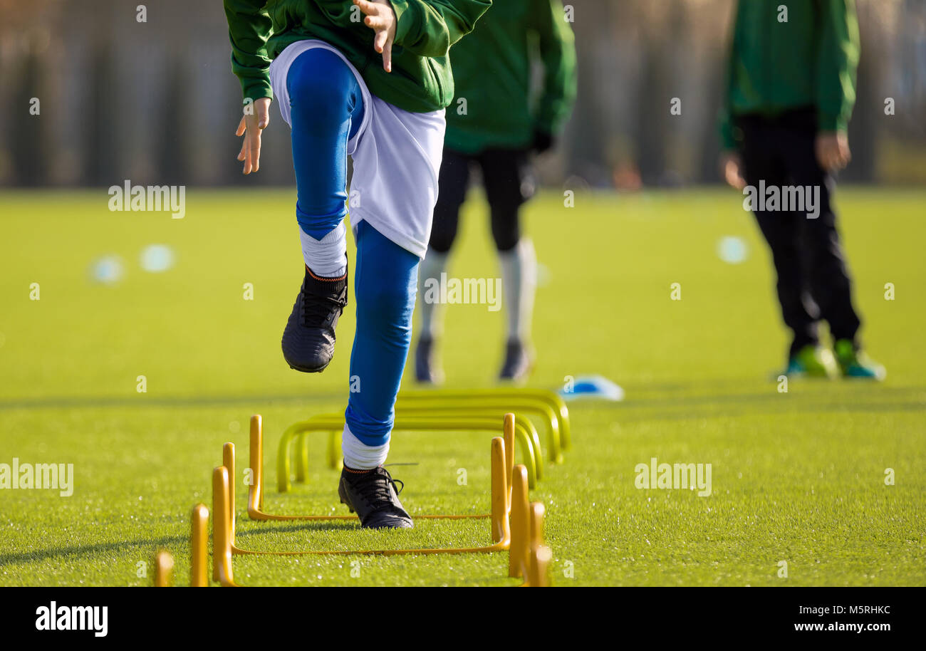 Boy Football Player In Training with Ladder. Young Soccer Players at Training Session. Soccer Speed Ladder Drills Stock Photo