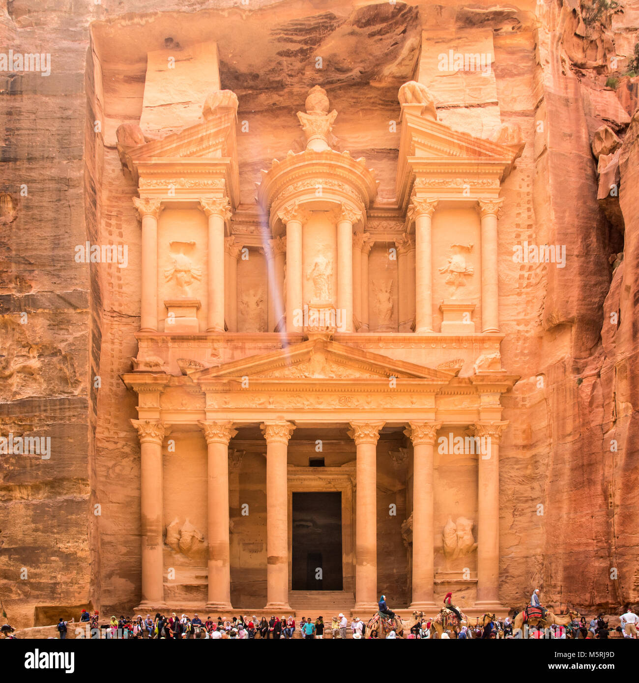 PETRA, JORDAN - APRIL 25, 2016: People near al-Khazneh temple (The Treasury) in ancient Petra. Rock-cut town Petra was established about 312 BC as the Stock Photo